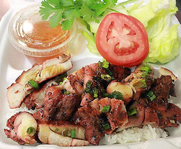 Grilled Chicken over Rice: A Flavorful Dish with Cucumber, Lettuce, Tomatoes, and Fish Sauce