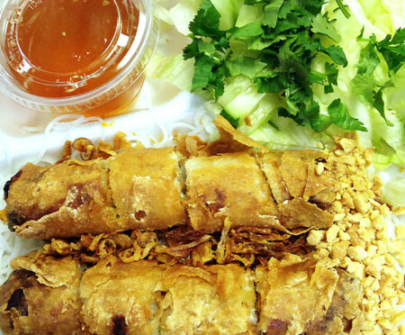 Eggroll Over Soft Rice Noodles: A Tasty Dish with Crispy Eggrolls, Fresh Veggies, and Delicious Toppings - A Flavorful Experience!