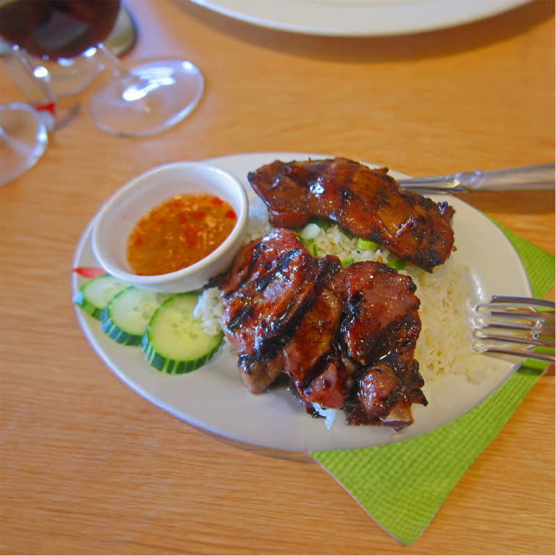 Grilled Pork over Rice: A Flavorful Dish with Cucumber, Lettuce, Tomatoes, and Fish Sauce